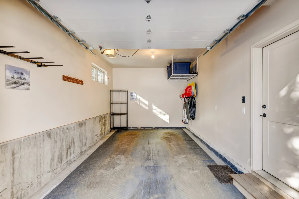 A clean, organized garage with ample storage shelves, tool hooks, and a tidy floor—perfect for stowing bikes and gear after a day outdoors.